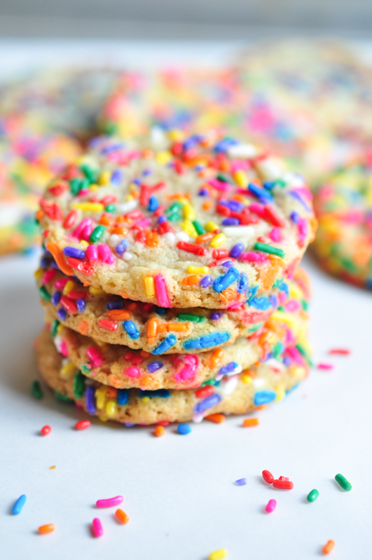  A stack of rainbow colored funfetti sugar cookies are waiting to be enjoyed 