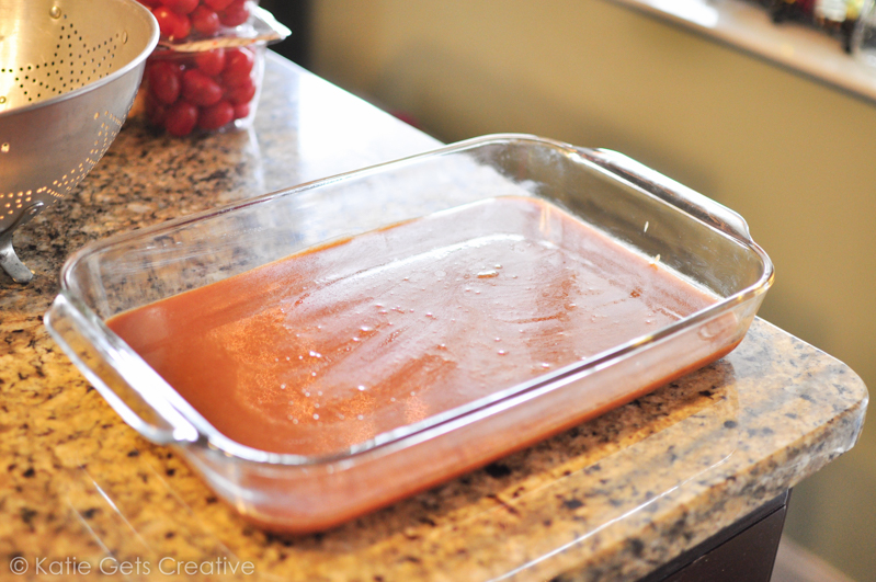 A glass dish of poured caramels waiting to cool 