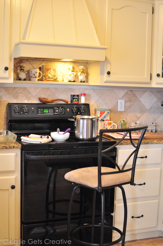 A kitchen set up for cooking goat milk caramels. Stovetop is prepped with stainless steel pan, candy thermometer and spoons for stirring. 