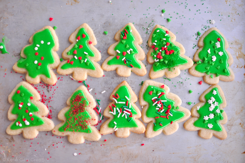 No Chill Roll Out Sugar Cookies in Christmas tree shapes with icing and sprinkles from www.katiegetscreative.com
