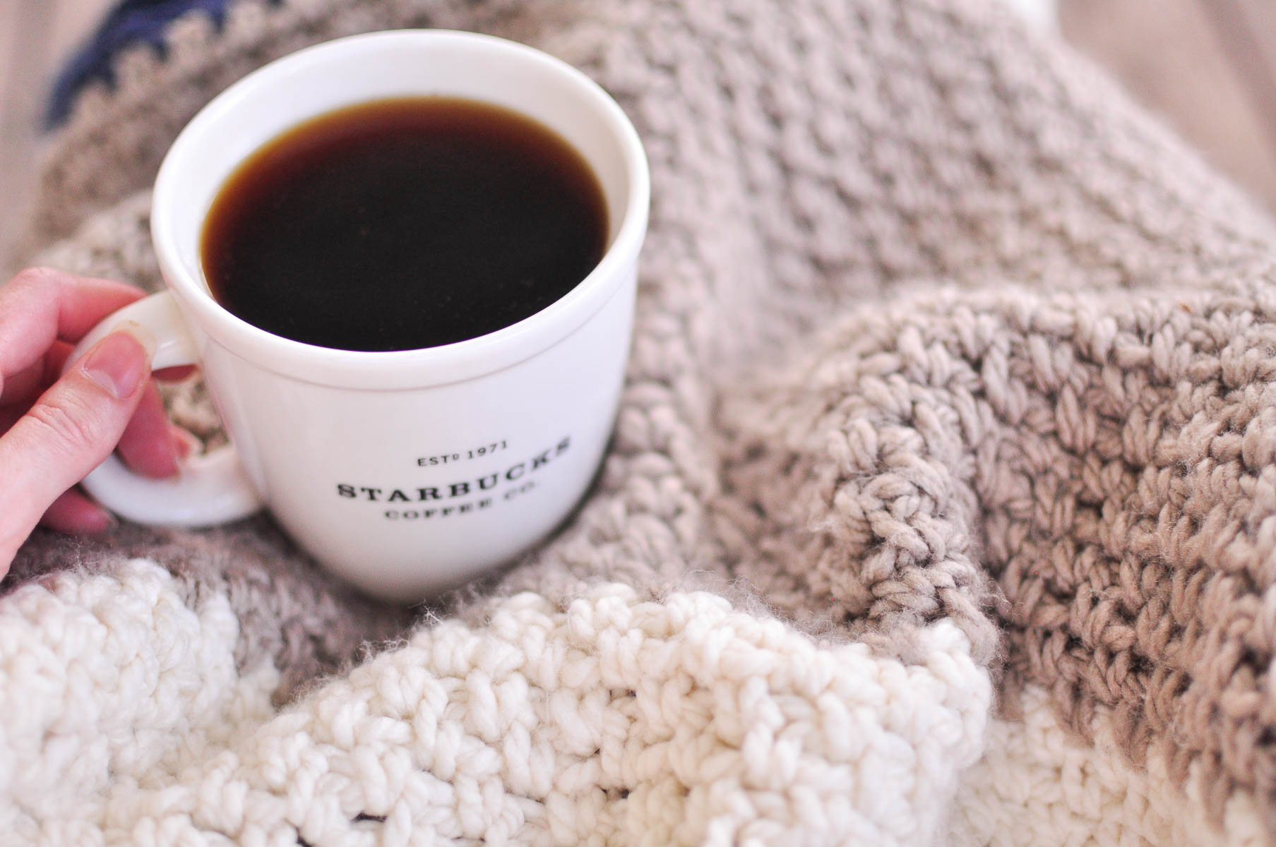 Moss stitch blanket and a cup of coffee.