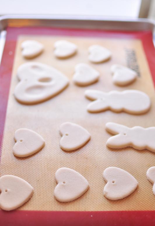 Salt dough ornaments on a silicone baking mat waiting to be baked 