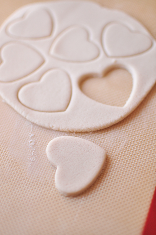 Heart shaped salt dough ornaments on a silicone baking mat
