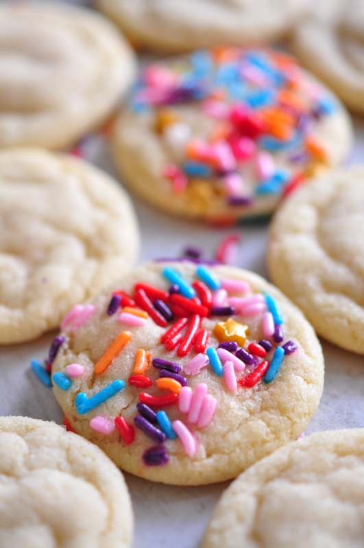 A tray of sugar cookies, some with sprinkles and some without 