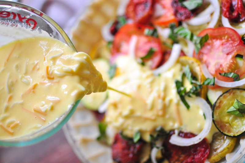 The ingredients for Tomato Zucchini Pie are being poured into a unbaked pie shell. 