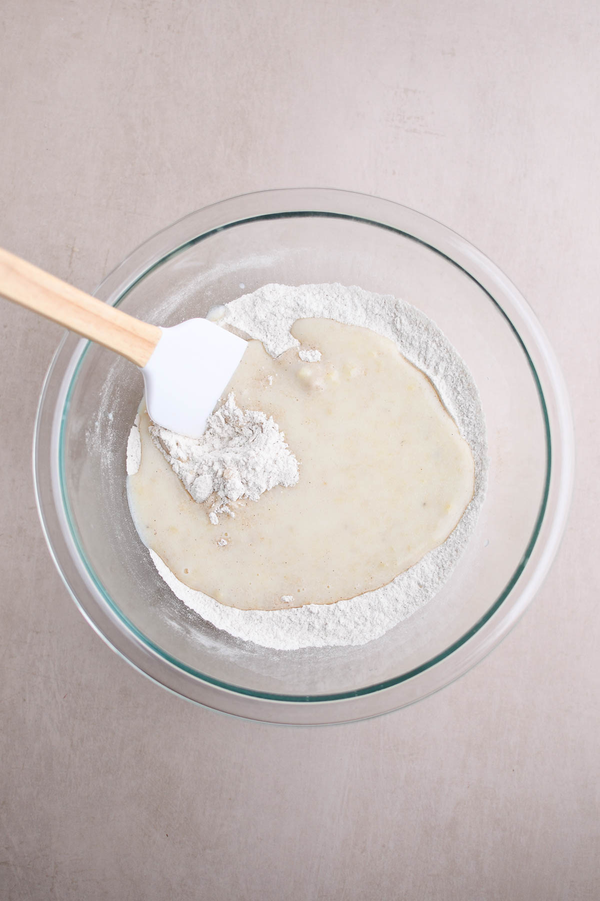 Adding wet ingredients to dry.