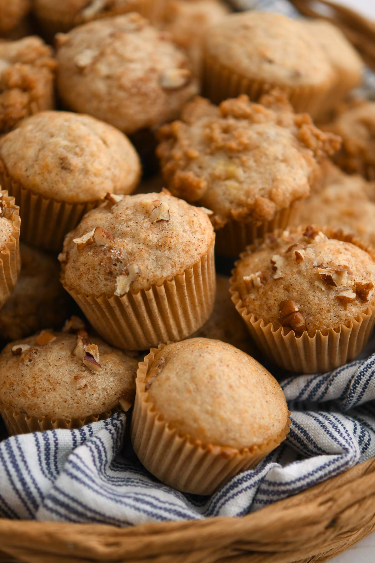 a stack of banana nut bread mini muffins in a basket.