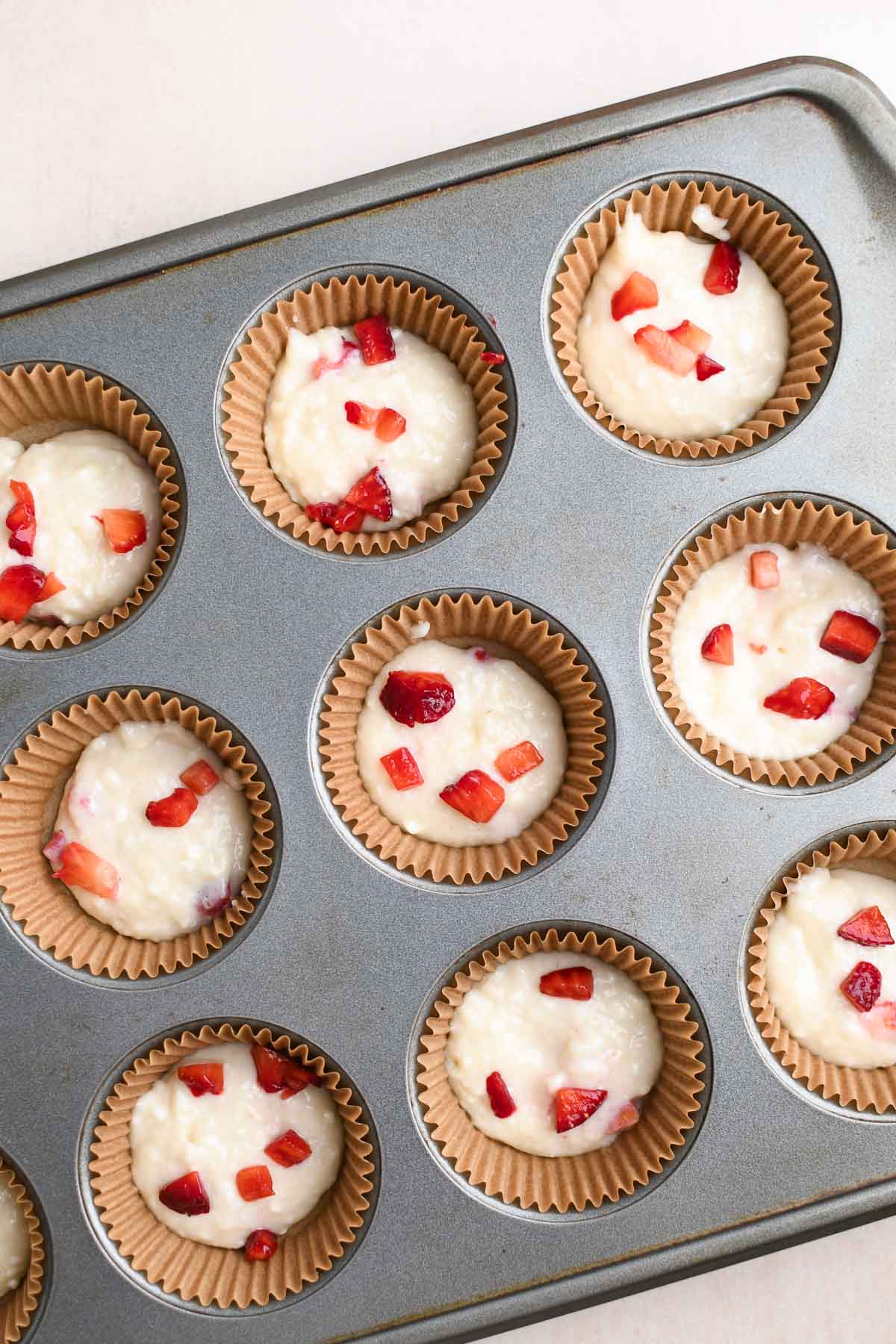 One scoop of batter and a layer of strawberries