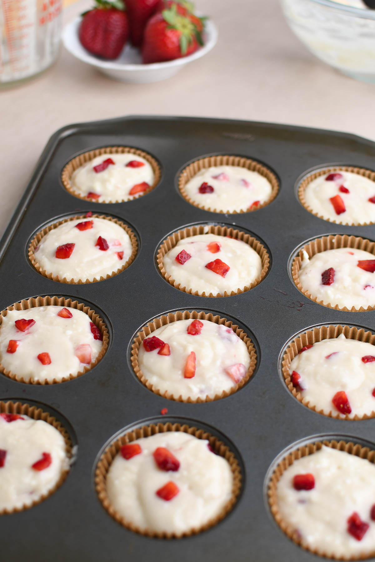 Filled muffin cups and final layer of strawberries