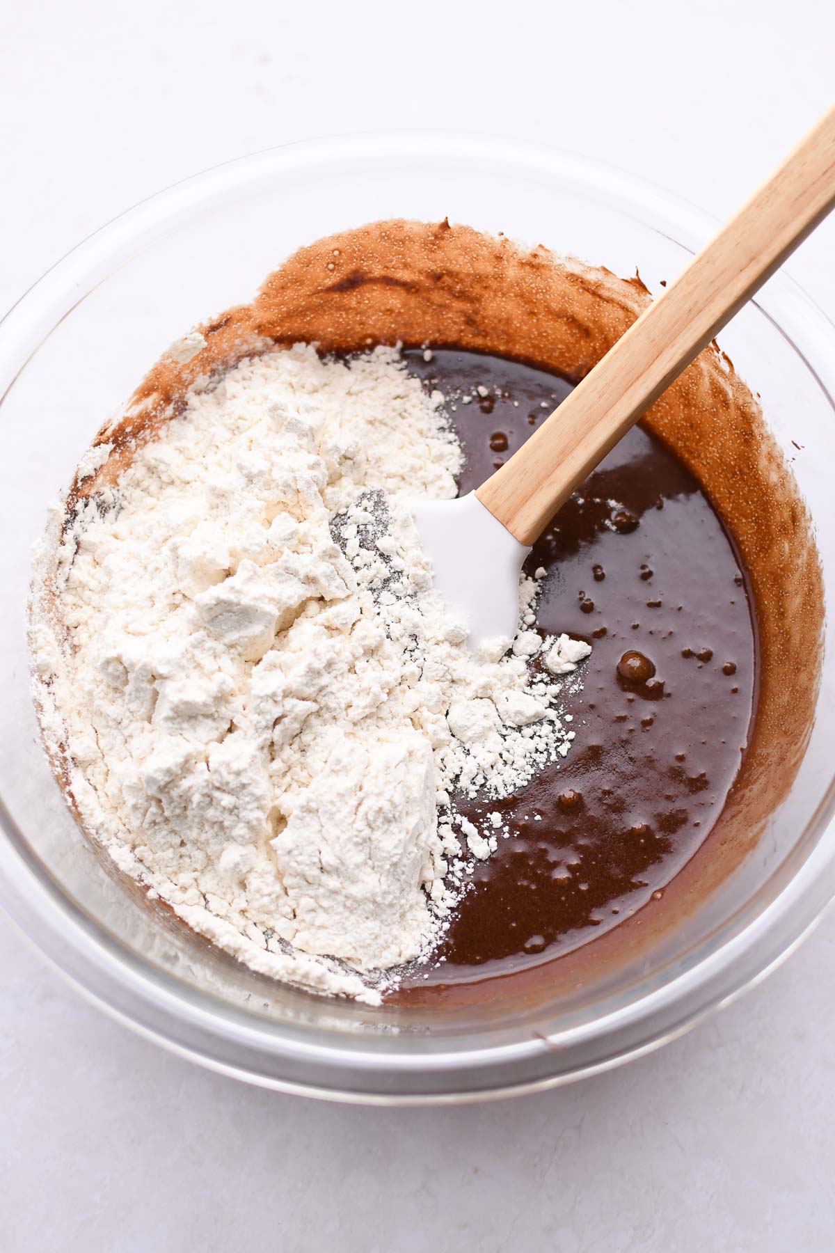 Adding flour to the batter. 