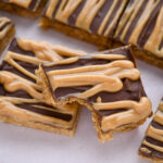 Slices of peanut butter fingers on a piece of parchment paper.