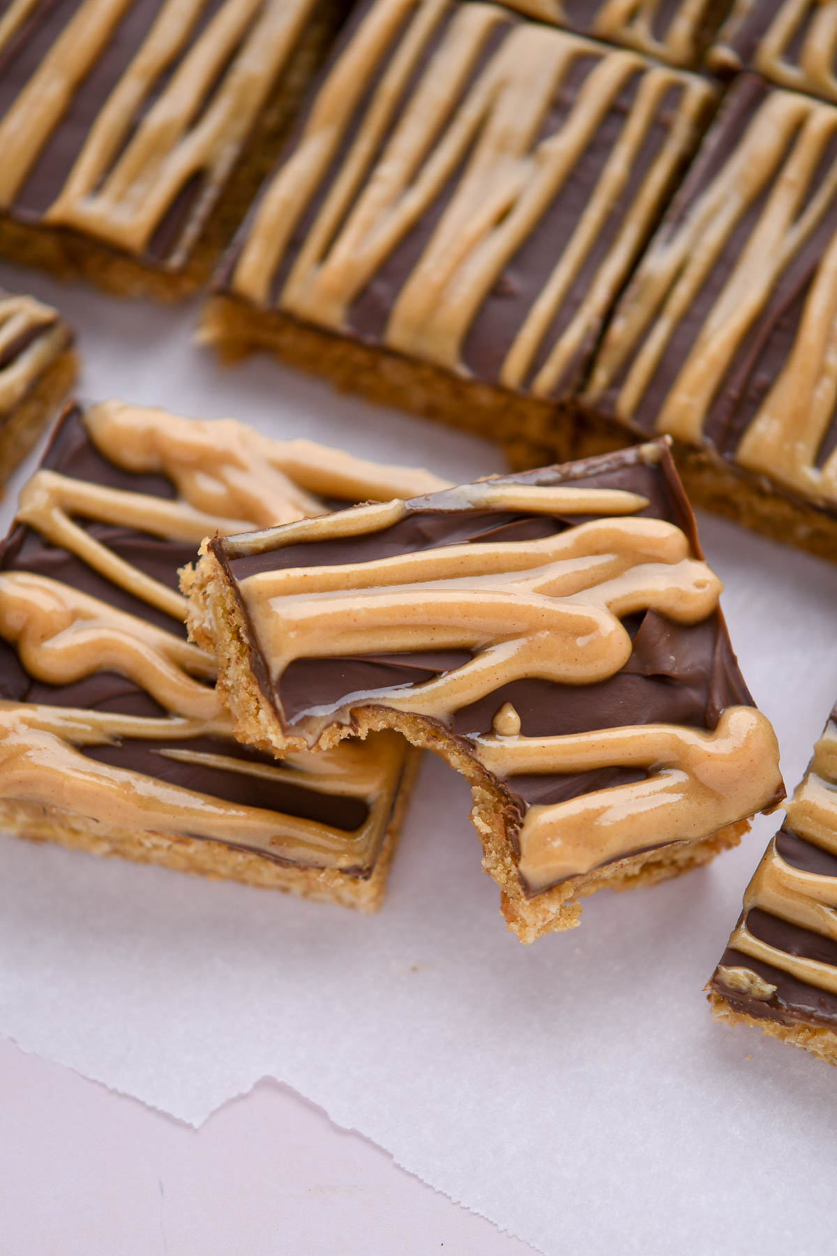 Slices of peanut butter fingers on a piece of parchment paper.