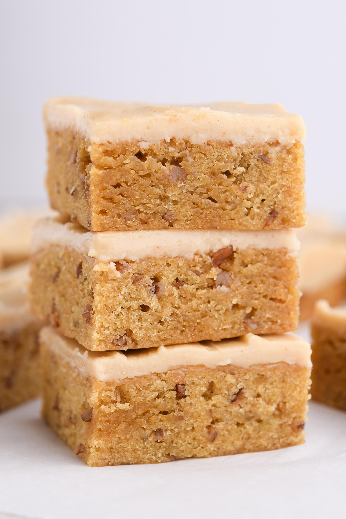 A stack of banana blondies with brown butter frosting.